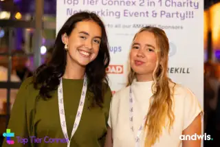 Guests in front of the event banner